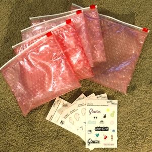Glossier pouches & stickers